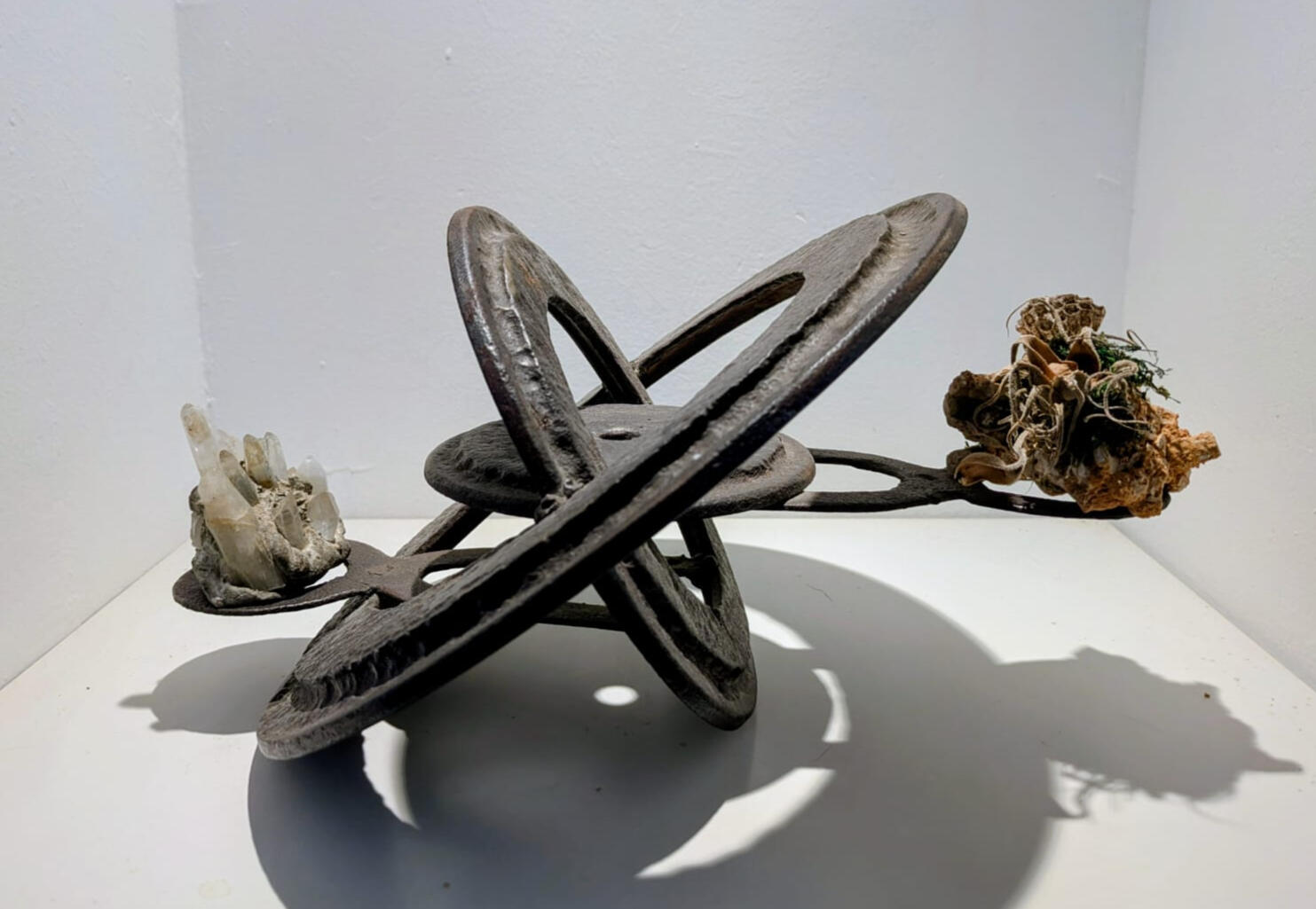Antique cast iron stove rings, salvaged kitchen door hinges, crystals, organic matter. H: 22 cm (approximate)