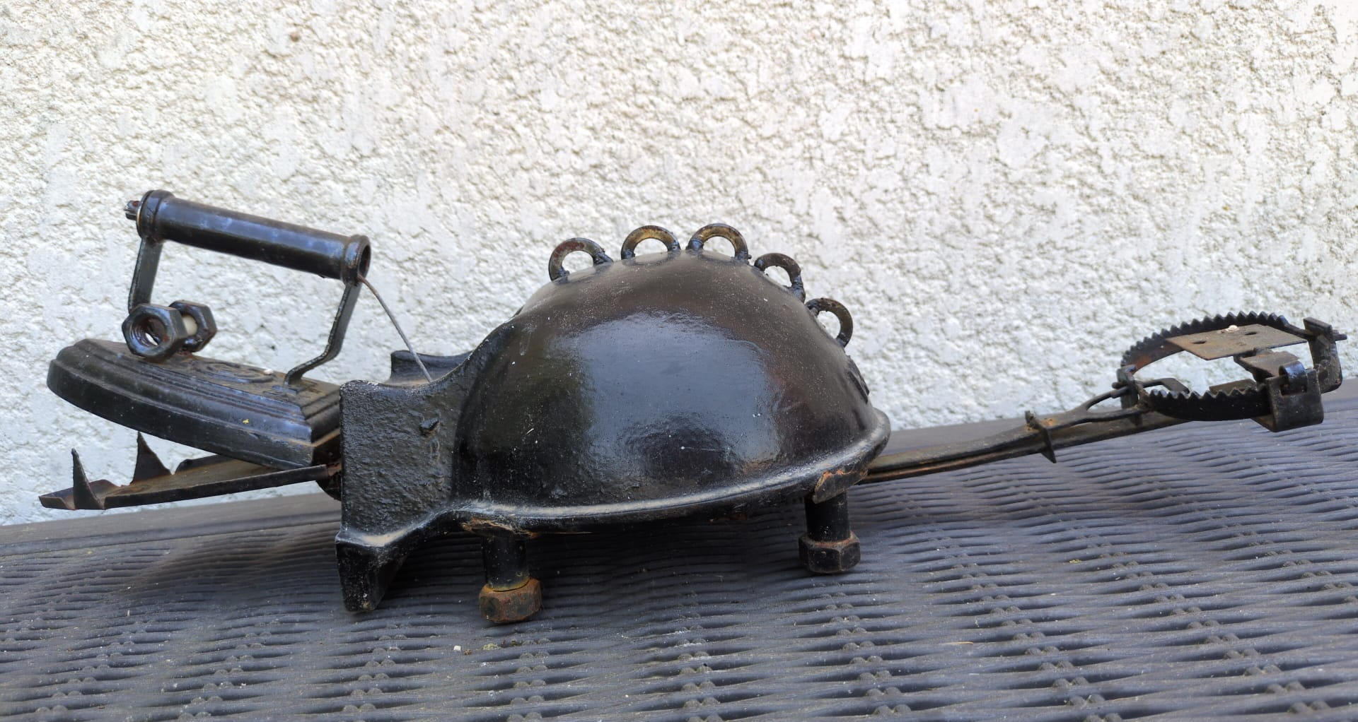 A little whimsy. Salvaged iron water trough, vintage flat iron, antique mechanical rat trap, steel wire. Dimensions variable | Kinetic sculpture